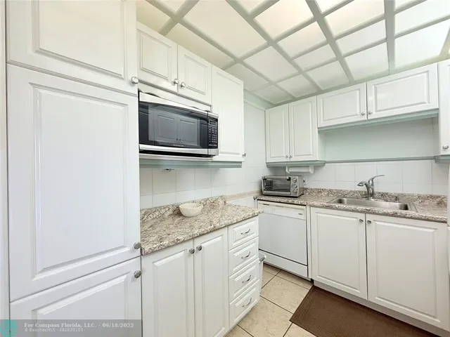 a kitchen with stainless steel appliances granite countertop a sink a stove and microwave