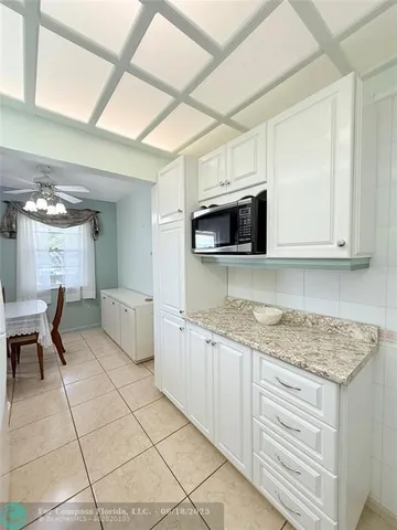 a kitchen with stainless steel appliances granite countertop a sink and a stove