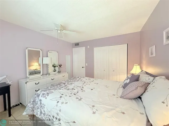 a bedroom with a large bed and a dresser