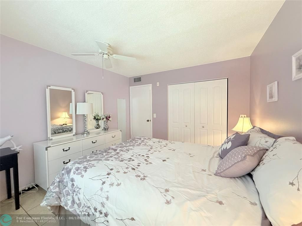 15 Markham A, Unit 15 Deerfield Beach, FL 33442 - Photo 23 of 45 a bedroom with a large bed and a dresser