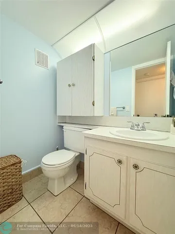 a bathroom with a sink toilet and mirror