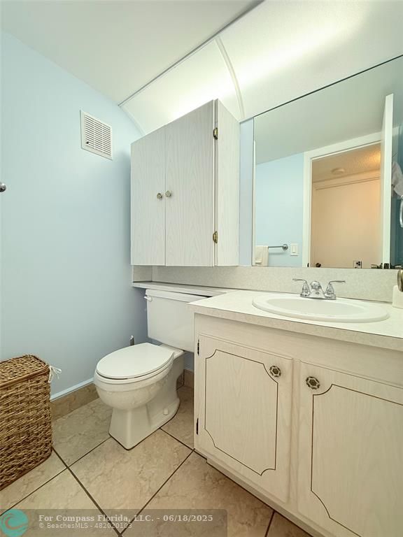 15 Markham A, Unit 15 Deerfield Beach, FL 33442 - Photo 25 of 45 a bathroom with a sink toilet and mirror