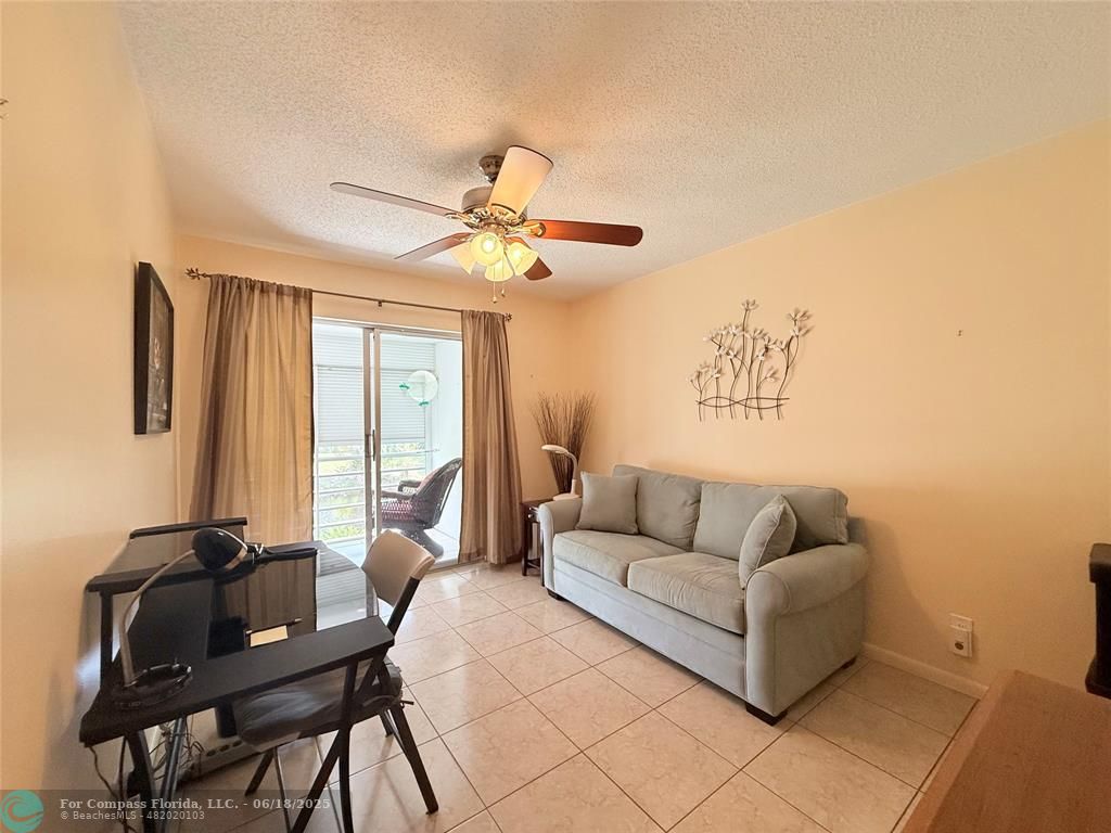 15 Markham A, Unit 15 Deerfield Beach, FL 33442 - Photo 26 of 45 a living room with furniture and a large window