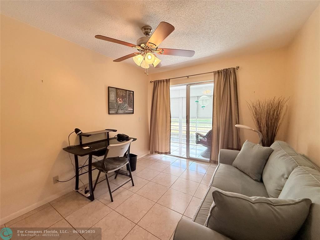 15 Markham A, Unit 15 Deerfield Beach, FL 33442 - Photo 27 of 45 a living room with furniture and a window