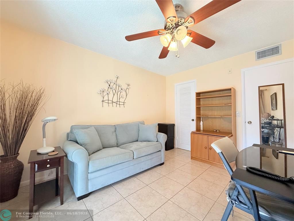 15 Markham A, Unit 15 Deerfield Beach, FL 33442 - Photo 29 of 45 a living room with furniture and a flat screen tv