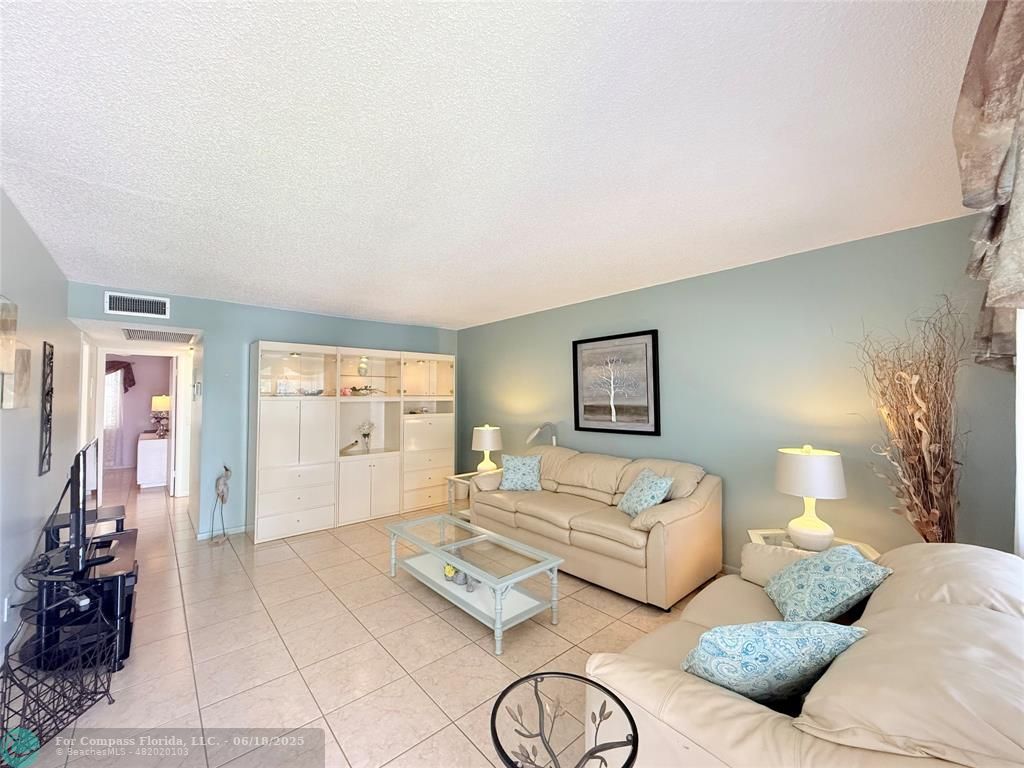 15 Markham A, Unit 15 Deerfield Beach, FL 33442 - Photo 3 of 45 a bedroom with a bed and wooden floor