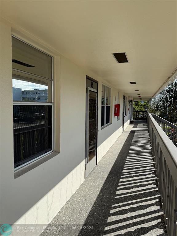 15 Markham A, Unit 15 Deerfield Beach, FL 33442 - Photo 34 of 45 a hallway with wooden floor windows and entryway