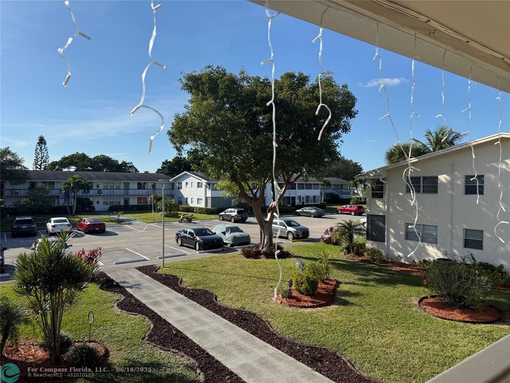 15 Markham A, Unit 15 Deerfield Beach, FL 33442 - Photo 35 of 45 a view of a house with a yard and sitting area