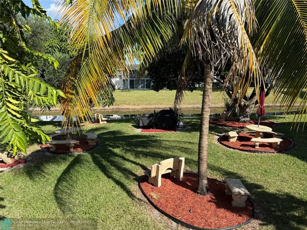 15 Markham A, Unit 15 Deerfield Beach, FL 33442 - Photo 38 of 45 a view of a park with potted plants and palm trees