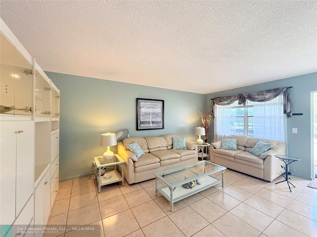 15 Markham A, Unit 15 Deerfield Beach, FL 33442 - Photo 4 of 45 a living room with furniture and a couch