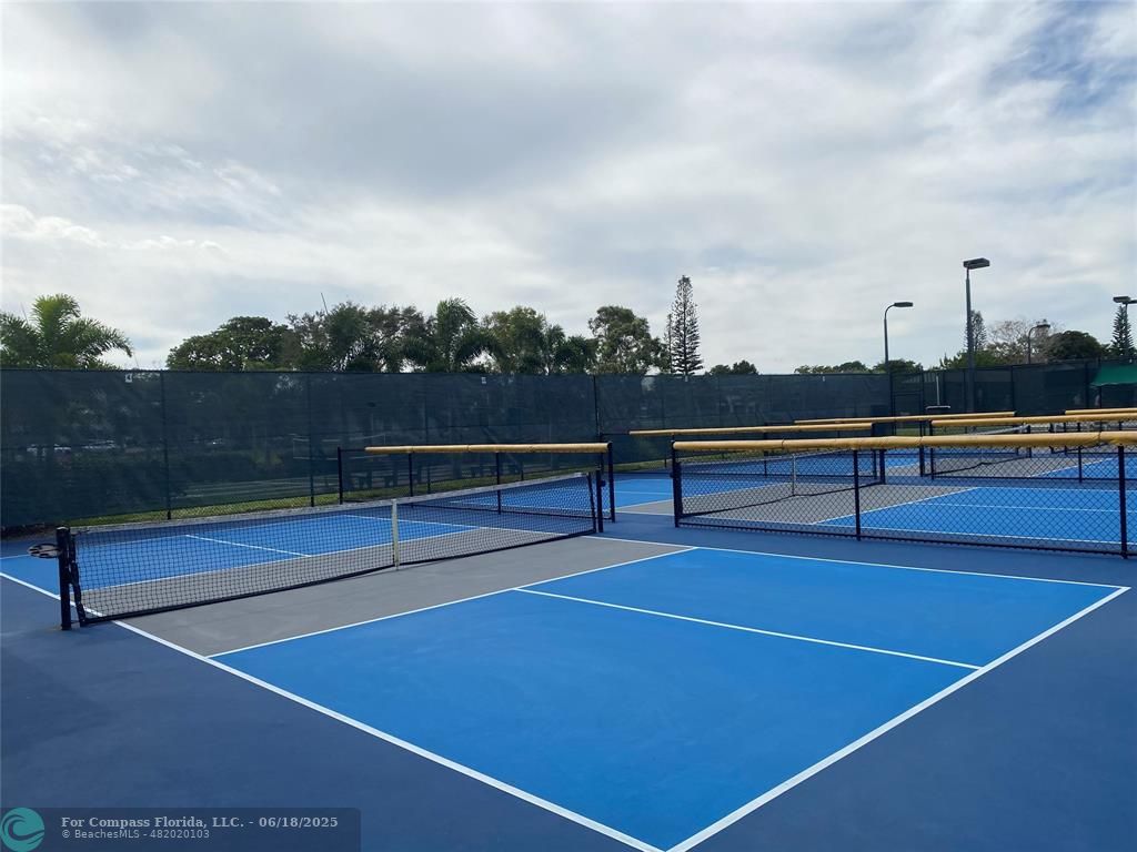 15 Markham A, Unit 15 Deerfield Beach, FL 33442 - Photo 41 of 45 a view of tennis court with houses