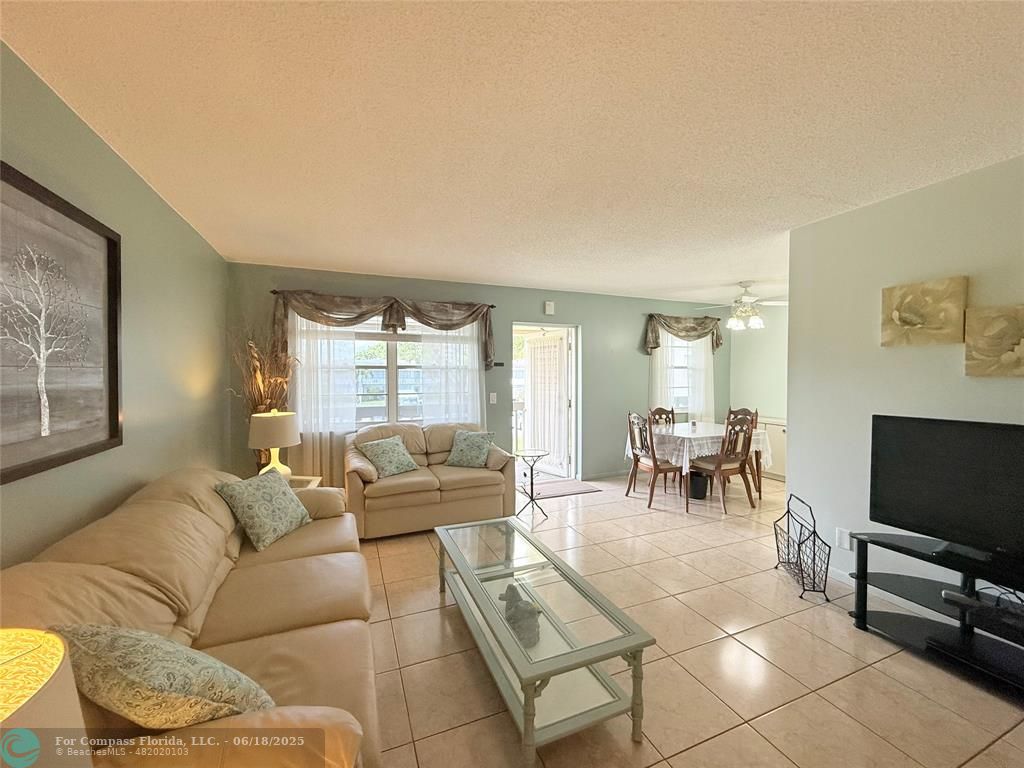 15 Markham A, Unit 15 Deerfield Beach, FL 33442 - Photo 5 of 45 a living room with furniture and a flat screen tv