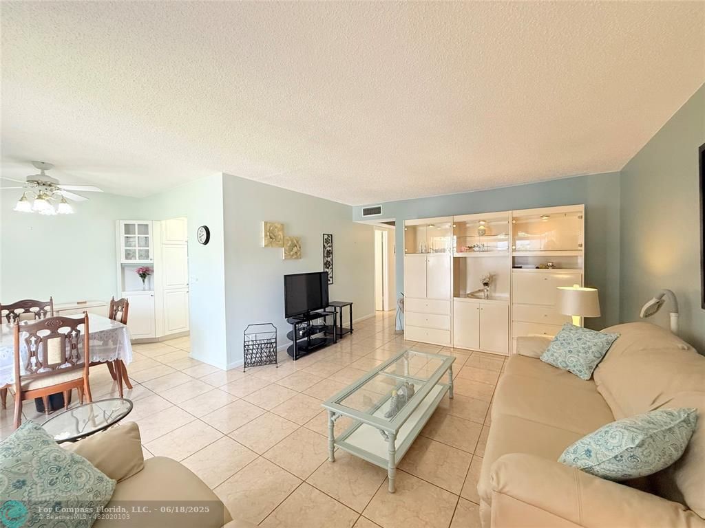 15 Markham A, Unit 15 Deerfield Beach, FL 33442 - Photo 6 of 45 a living room with furniture and a flat screen tv