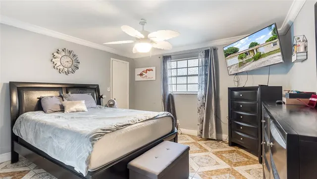 a bedroom with a bed and a television