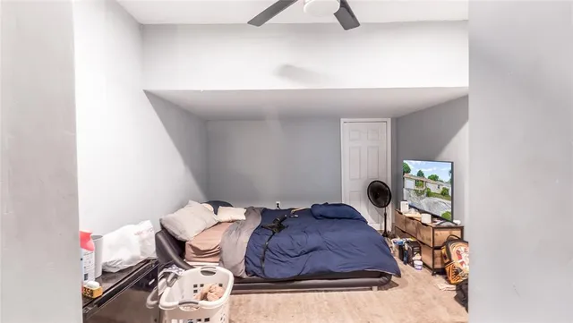 a bed sitting in a bedroom next to a lamp