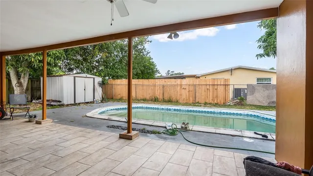 a room with pool table and windows