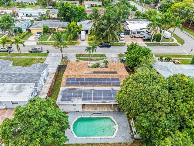a view of a swimming pool with a garden and plants