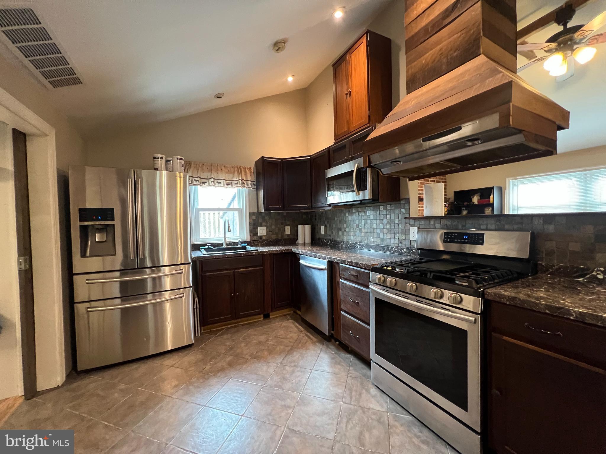 30 Duane Road Doylestown, PA 18901 - Photo 22 of 26 a kitchen with stainless steel appliances granite countertop a stove and a refrigerator