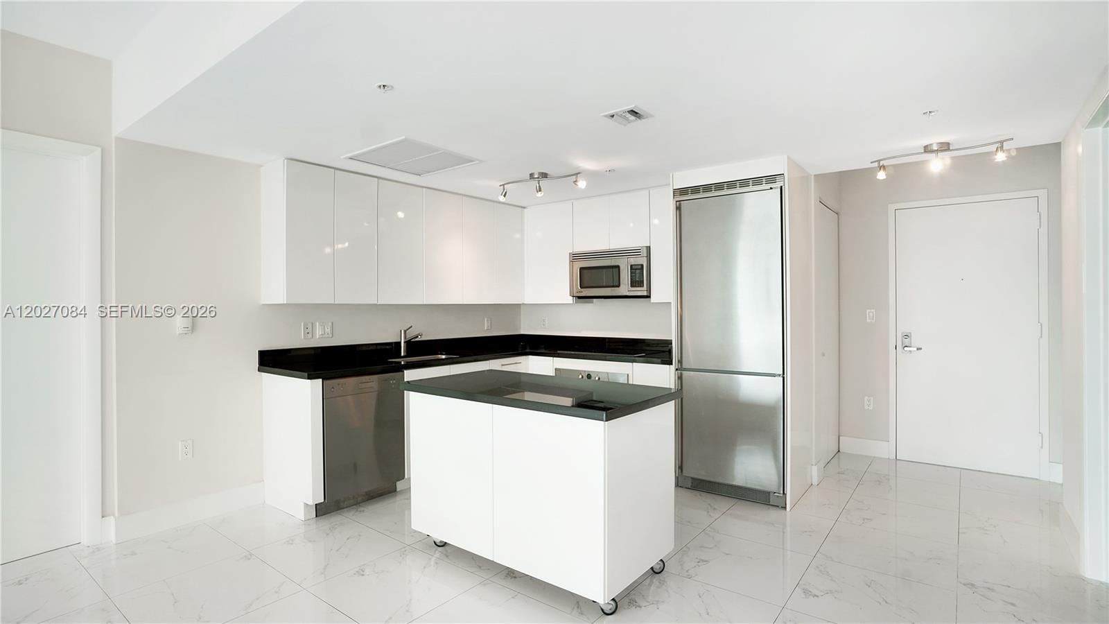 92 Southwest 3rd Street, Unit 1803 Miami, FL 33130 - Photo 2 of 29 a kitchen with a sink appliances and cabinets