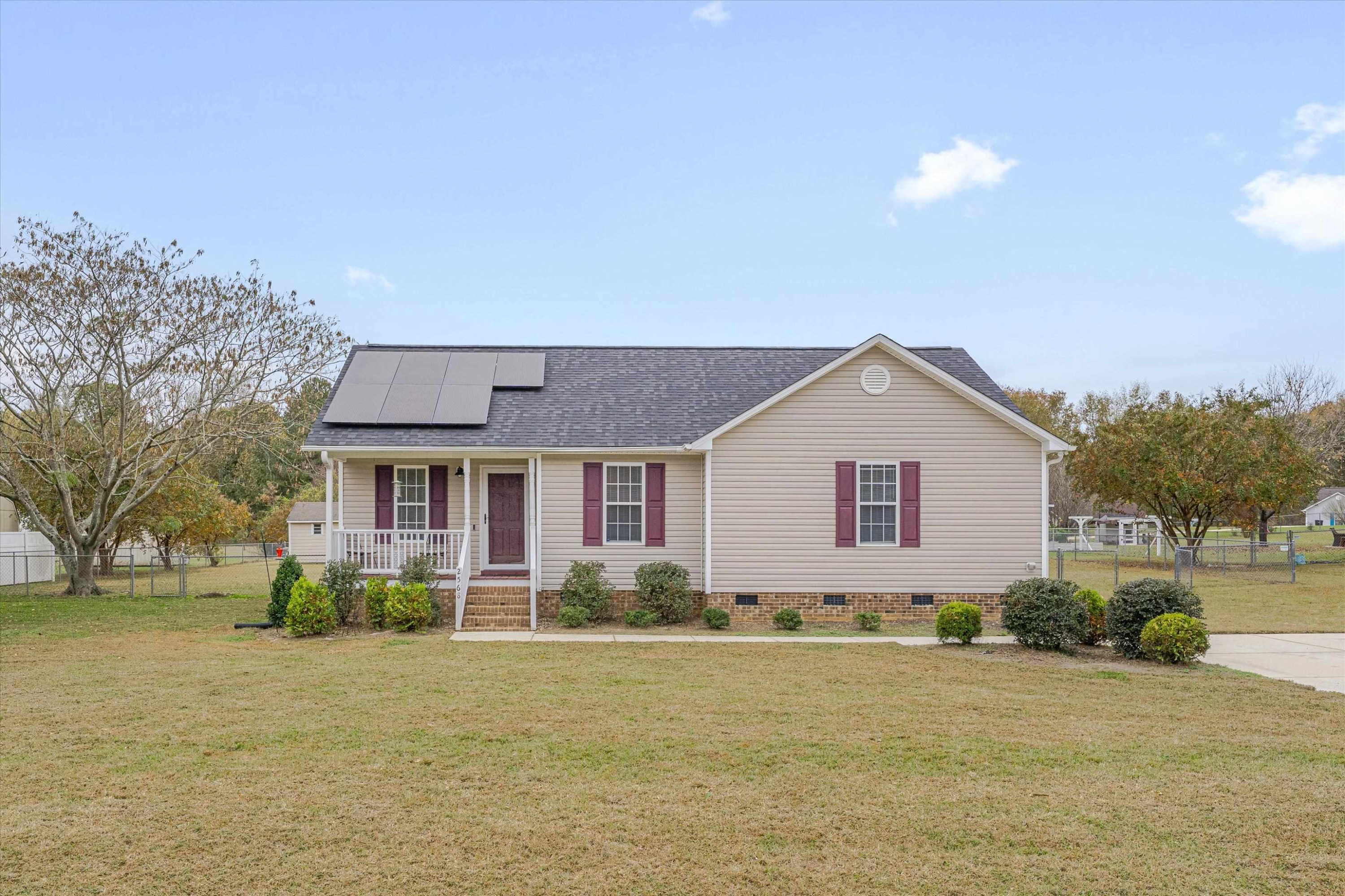 2568 Matthews Road Clayton, NC 27520 - Photo 1 of 26 a front view of house with yard and trees around