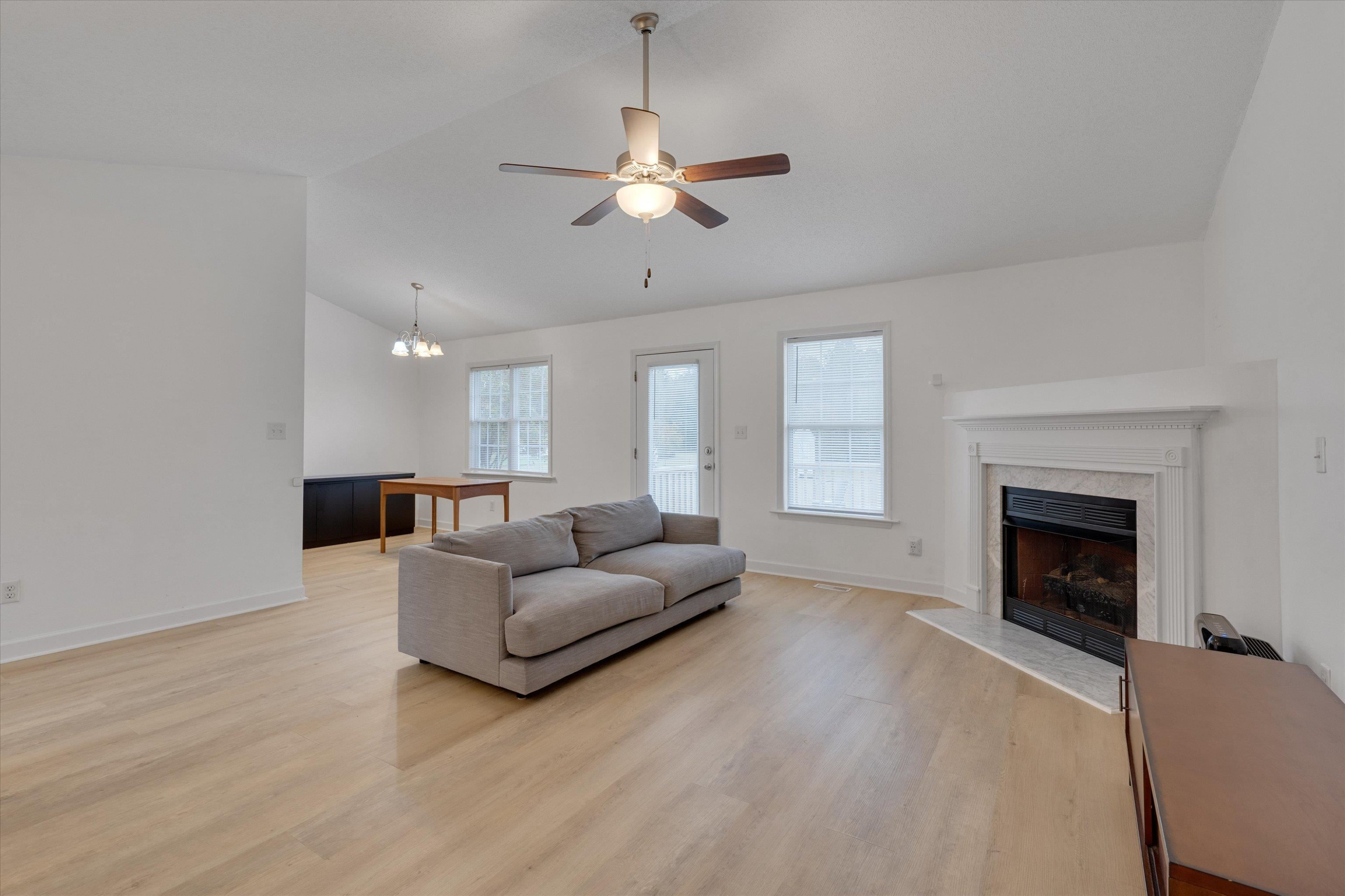 2568 Matthews Road Clayton, NC 27520 - Photo 12 of 26 a living room with furniture and a fireplace