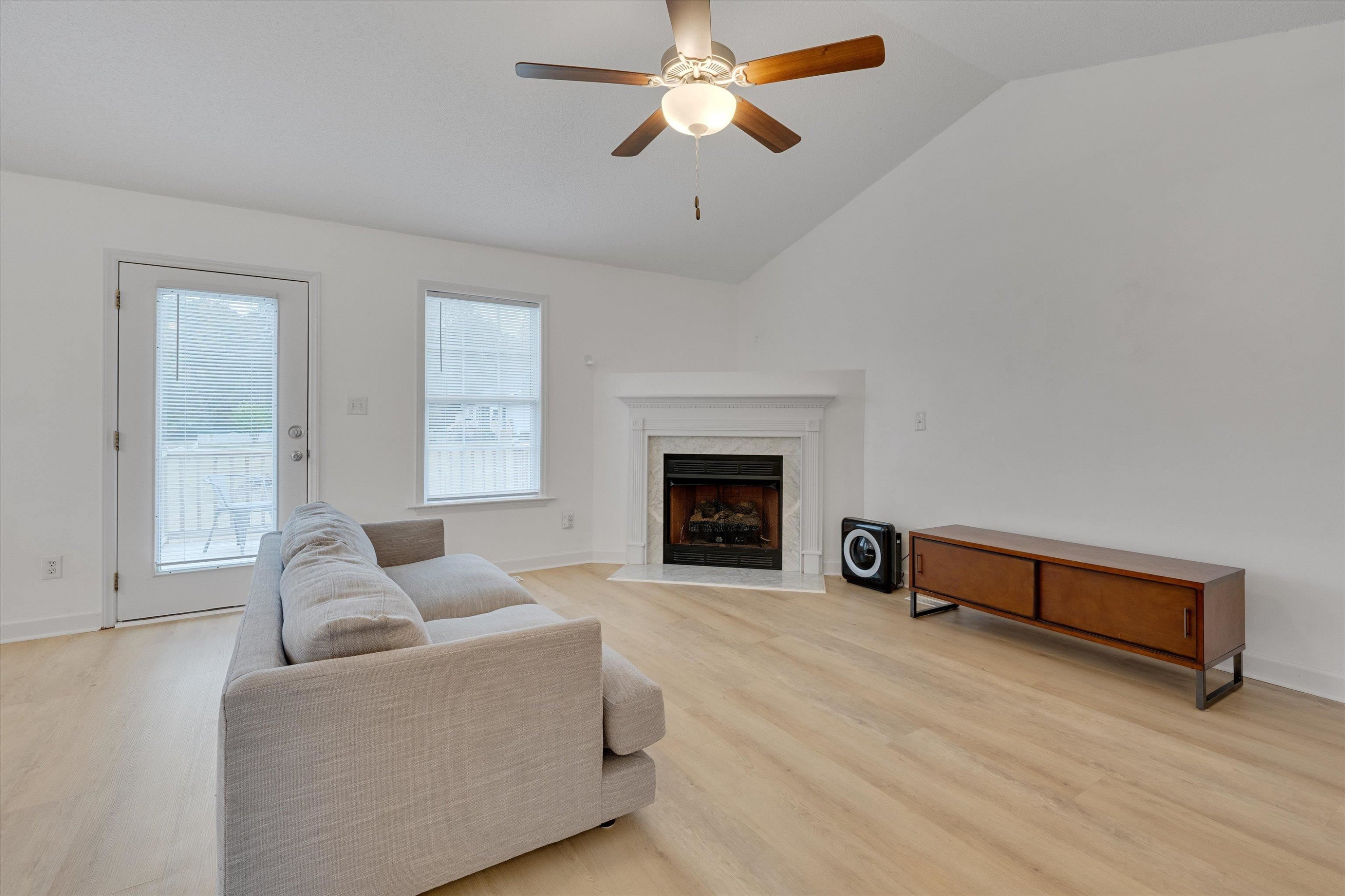 2568 Matthews Road Clayton, NC 27520 - Photo 13 of 26 a living room with furniture and a fireplace
