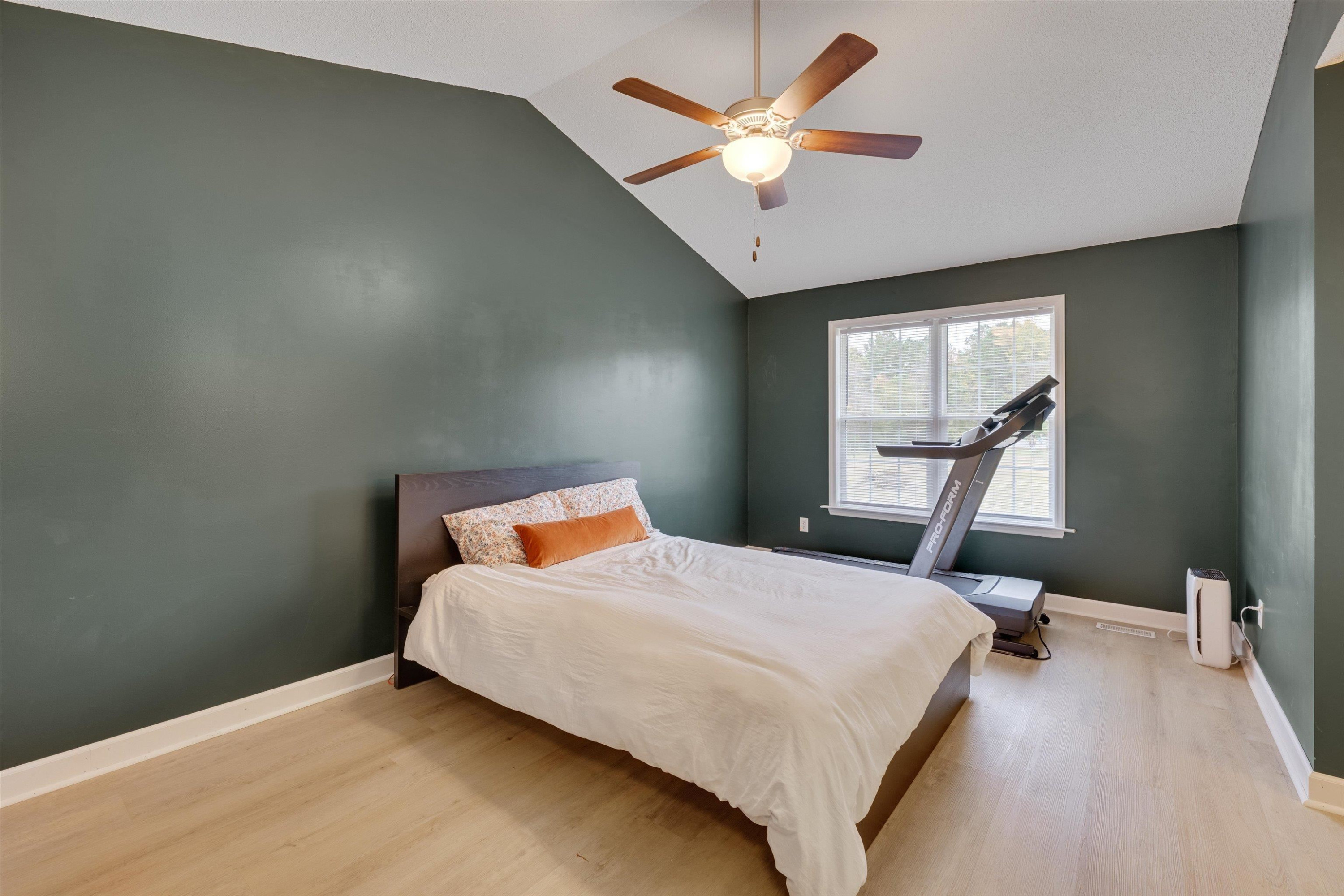 2568 Matthews Road Clayton, NC 27520 - Photo 14 of 26 a bedroom with a bed window and a chandelier