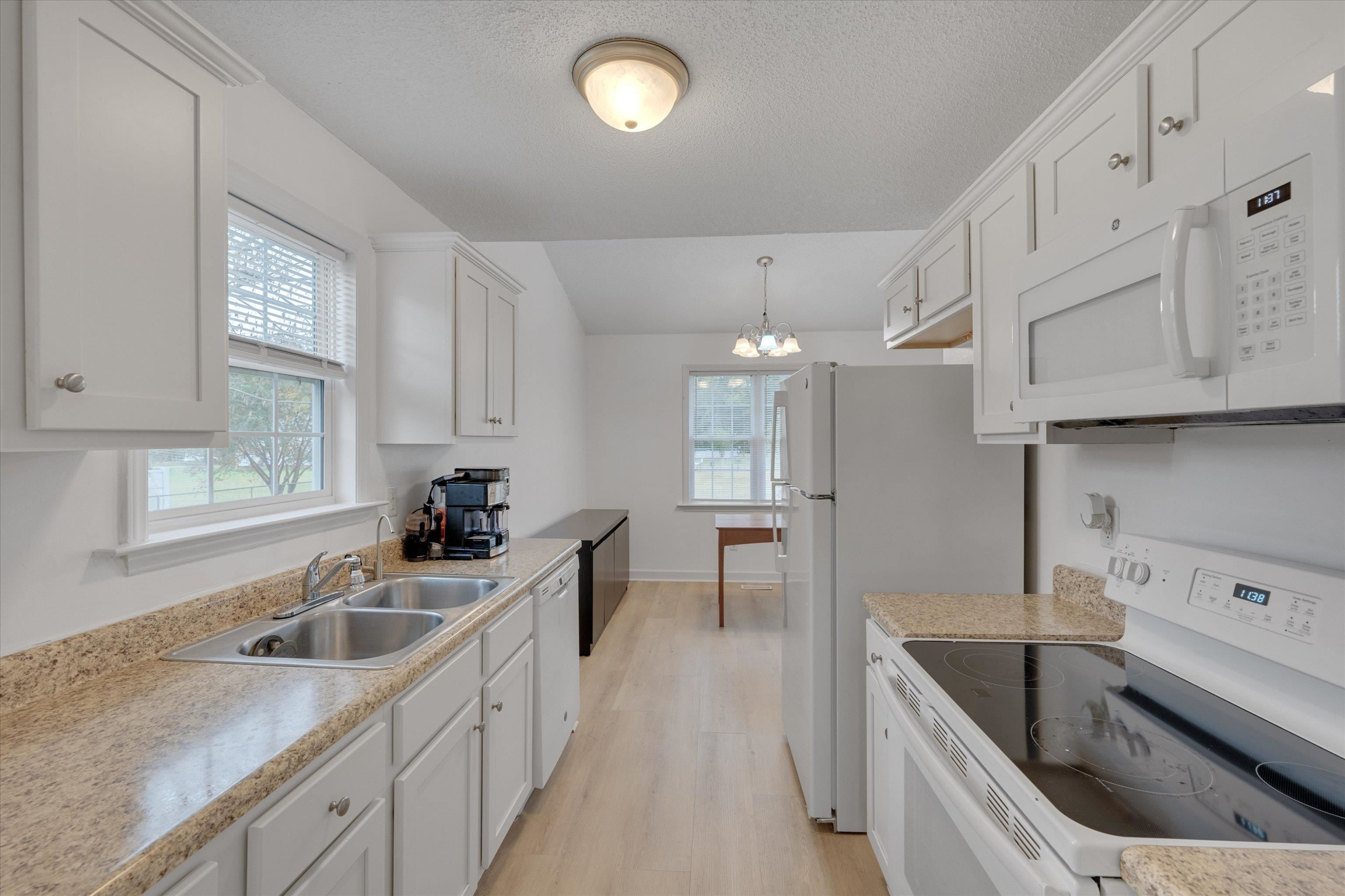 2568 Matthews Road Clayton, NC 27520 - Photo 20 of 26 a kitchen that has a sink and a stove