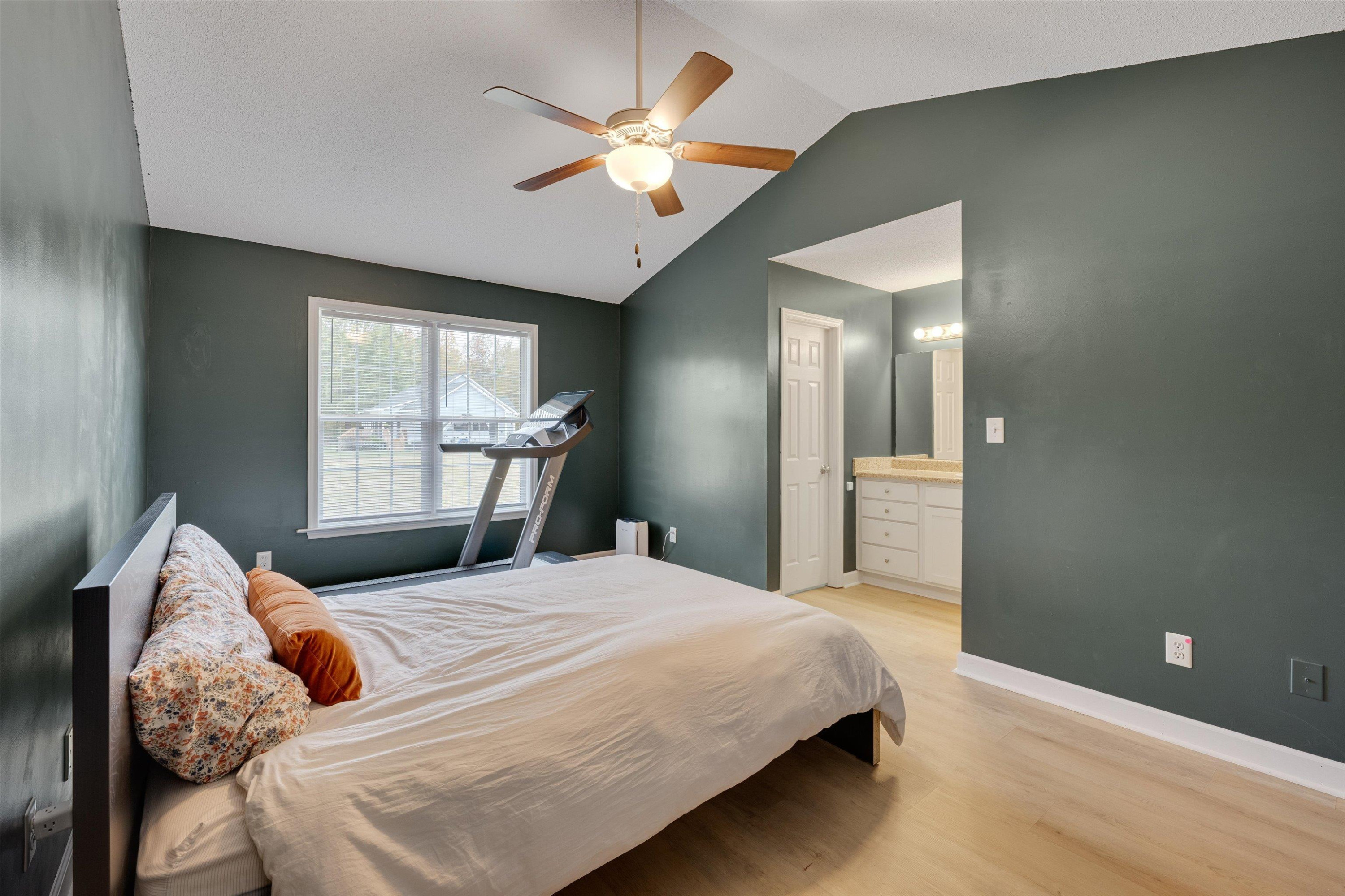 2568 Matthews Road Clayton, NC 27520 - Photo 24 of 26 a bedroom with a large bed and a chandelier