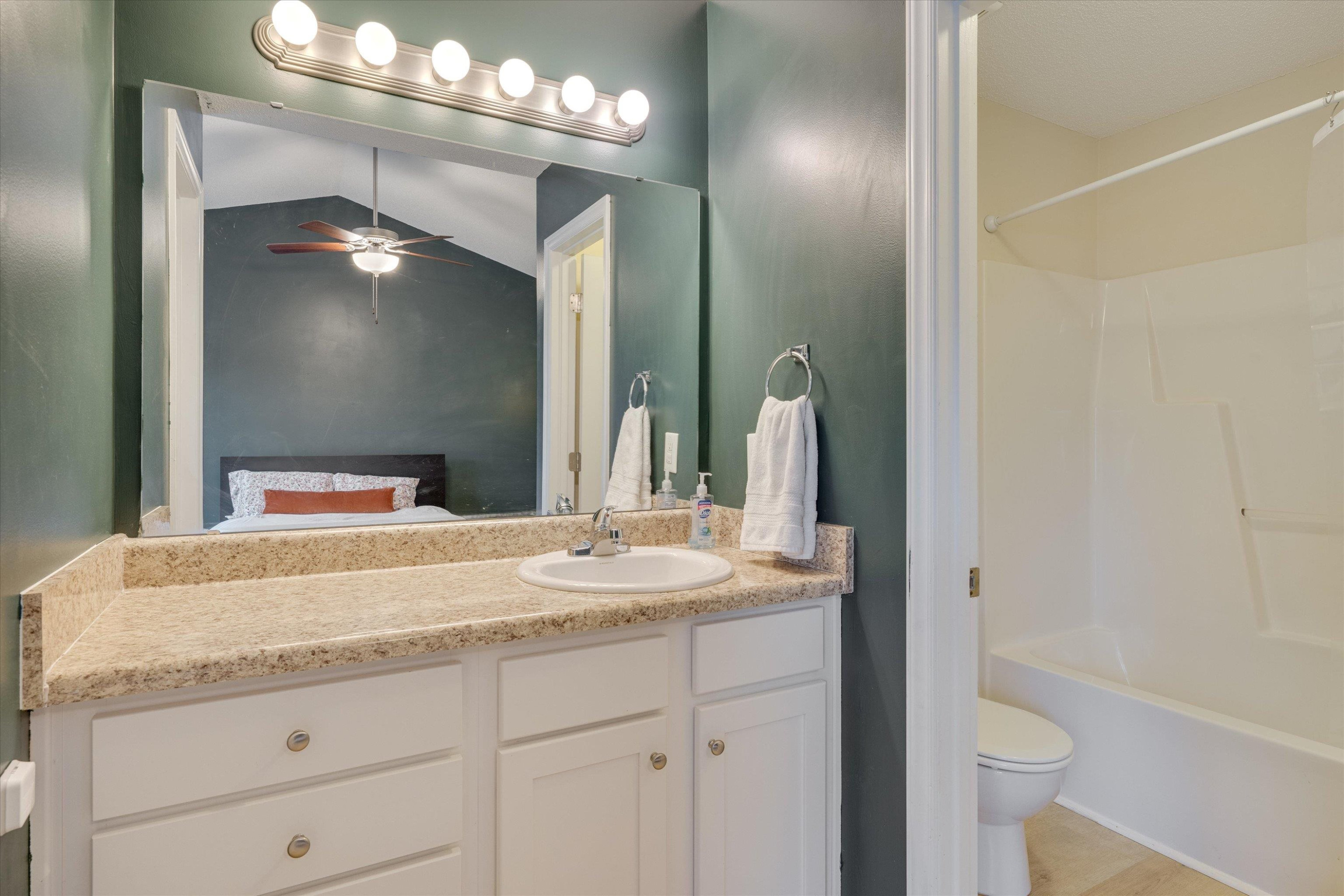 2568 Matthews Road Clayton, NC 27520 - Photo 25 of 26 a bathroom with a granite countertop sink toilet and a mirror