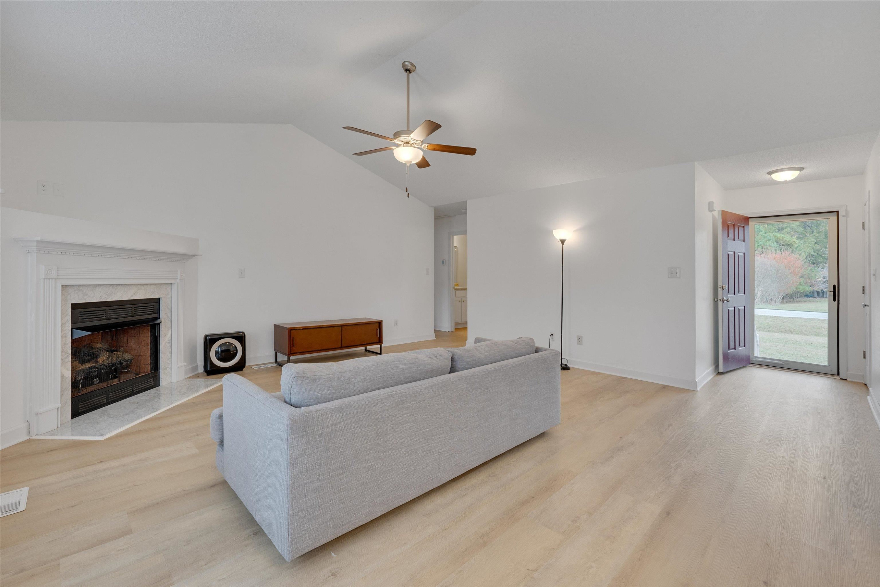 2568 Matthews Road Clayton, NC 27520 - Photo 8 of 26 a living room with furniture and a chandelier