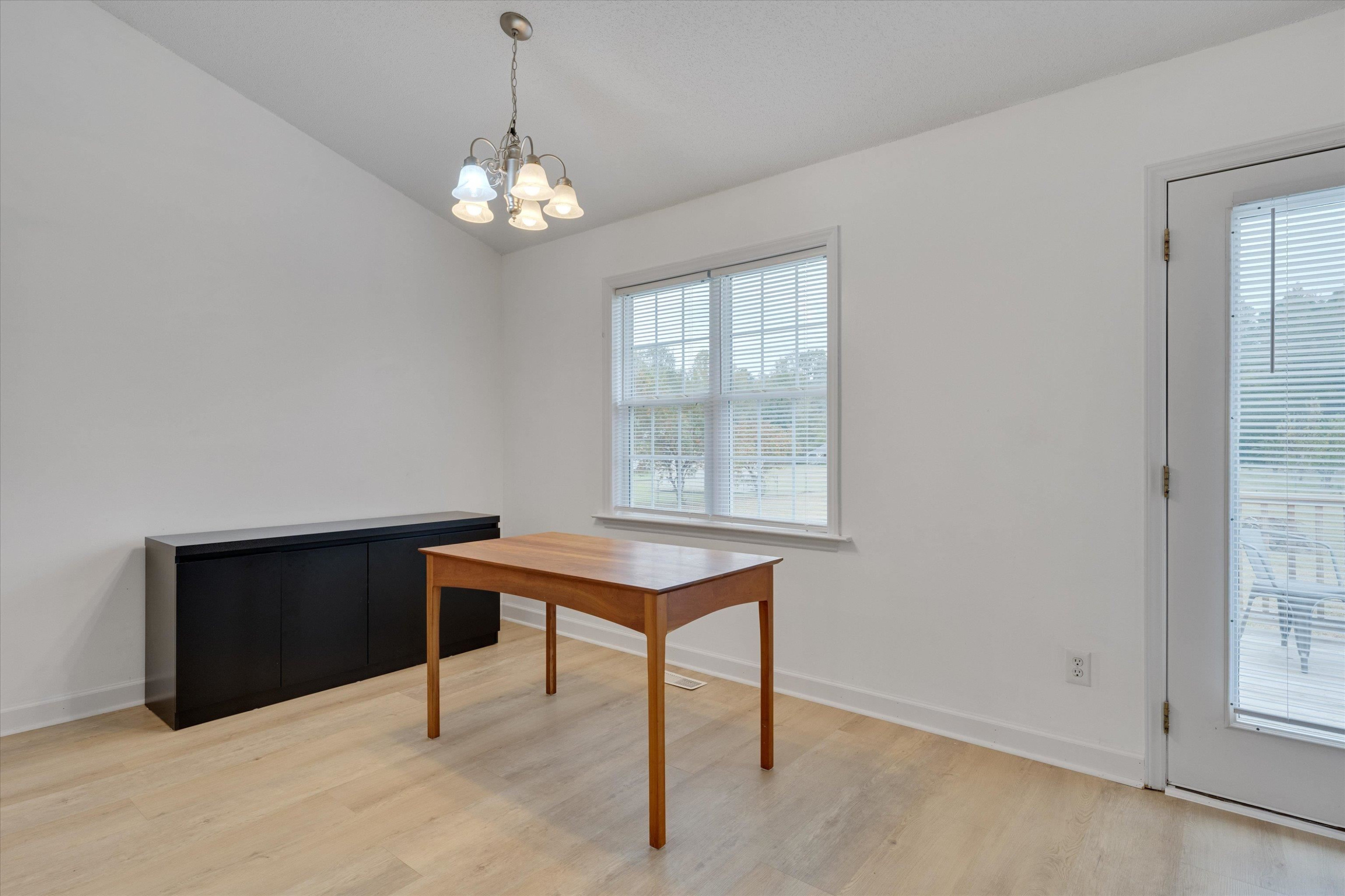 2568 Matthews Road Clayton, NC 27520 - Photo 10 of 26 a room with chandelier fan and windows