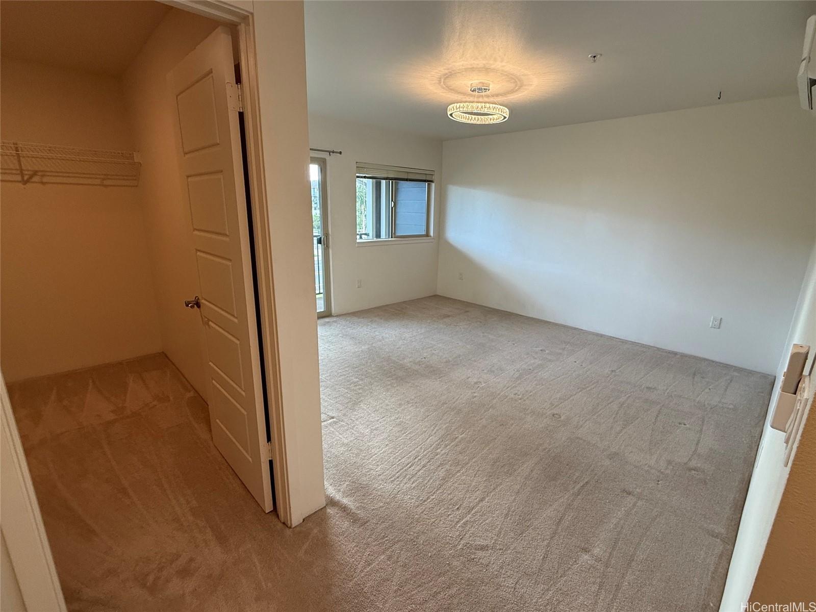91-3524 Iwikuamo'o Street, Unit 102 Ewa Beach, HI 96706 - Photo 13 of 25 wooden floor in an empty room with a window