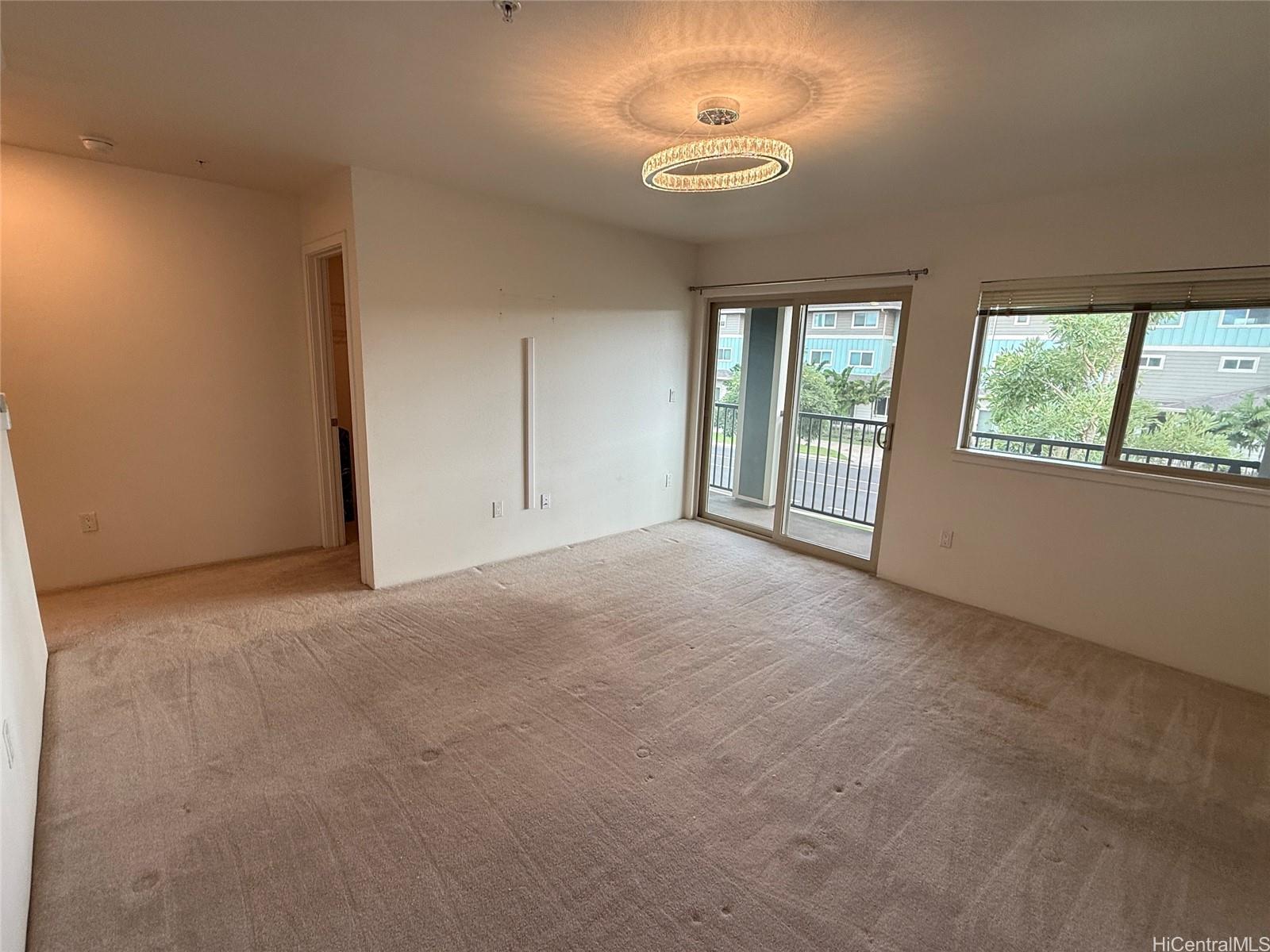 91-3524 Iwikuamo'o Street, Unit 102 Ewa Beach, HI 96706 - Photo 14 of 25 a view of empty room with windows