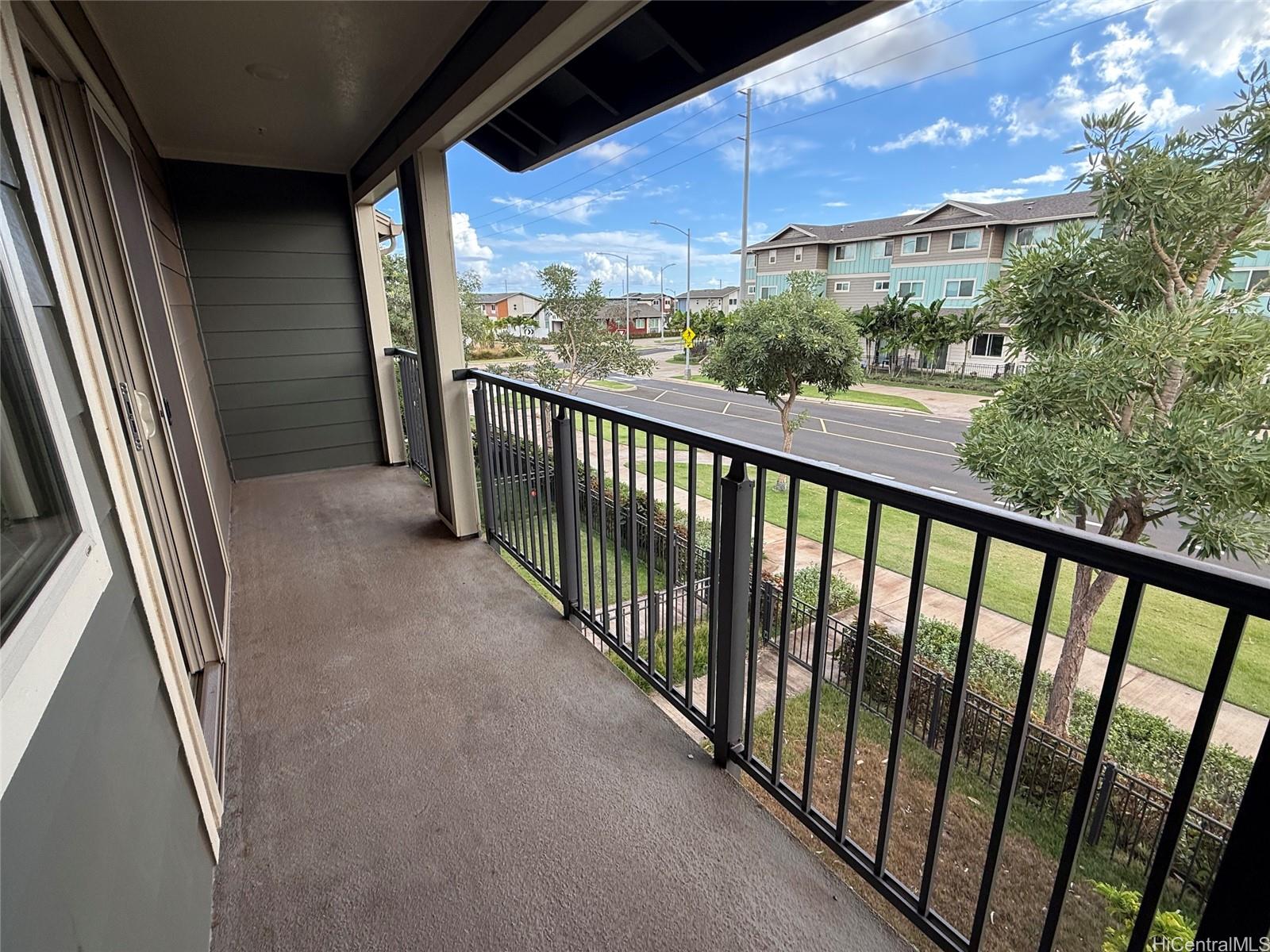 91-3524 Iwikuamo'o Street, Unit 102 Ewa Beach, HI 96706 - Photo 16 of 25 a view of balcony with wooden floor and fence
