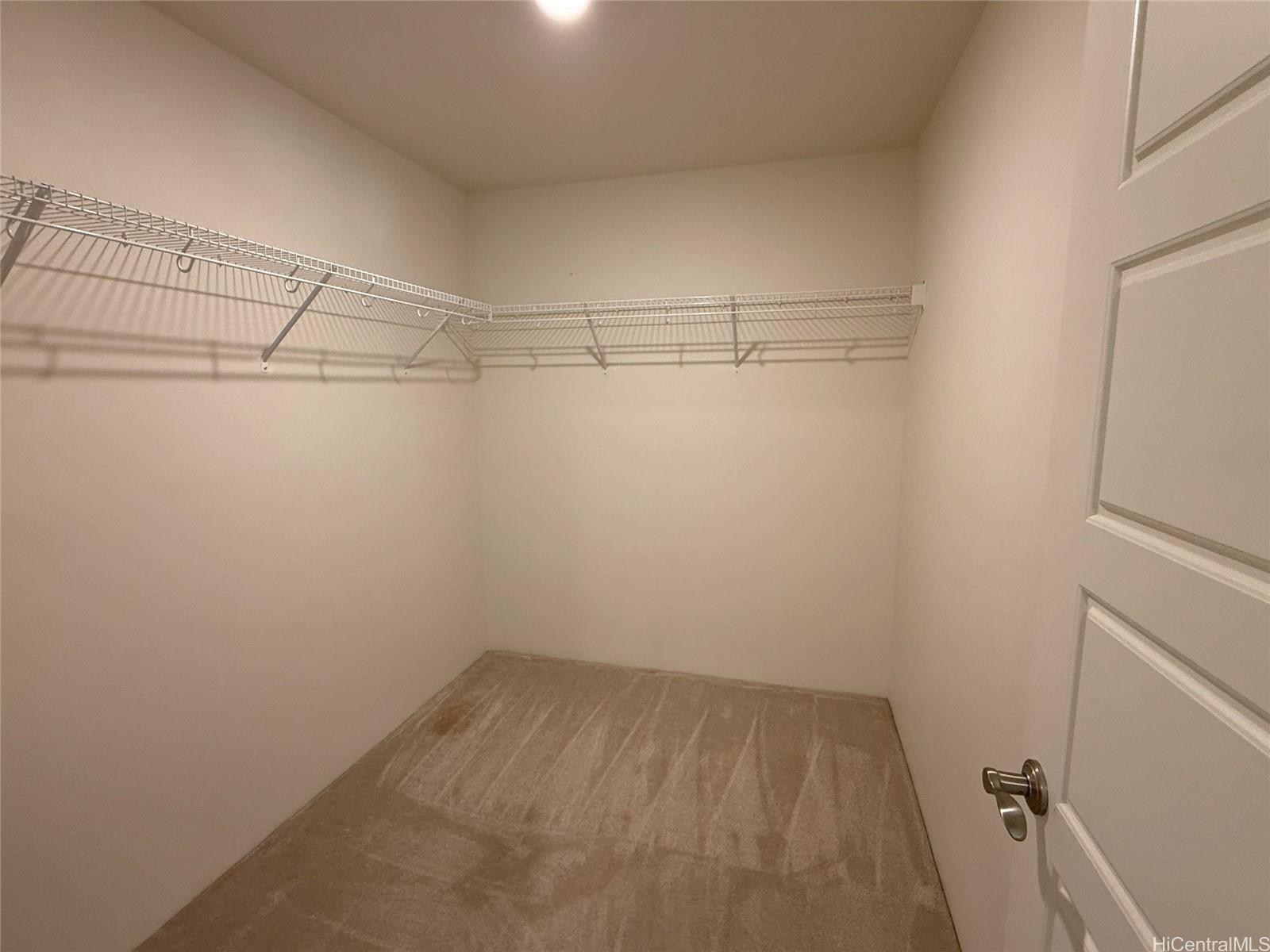 91-3524 Iwikuamo'o Street, Unit 102 Ewa Beach, HI 96706 - Photo 17 of 25 a view of a room with racks on the wall