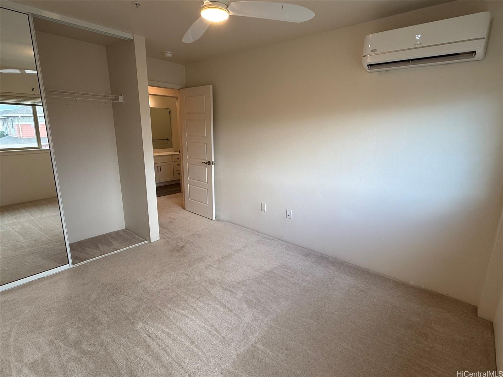 91-3524 Iwikuamo'o Street, Unit 102 Ewa Beach, HI 96706 - Photo 21 of 25 an empty room with closet and wooden door