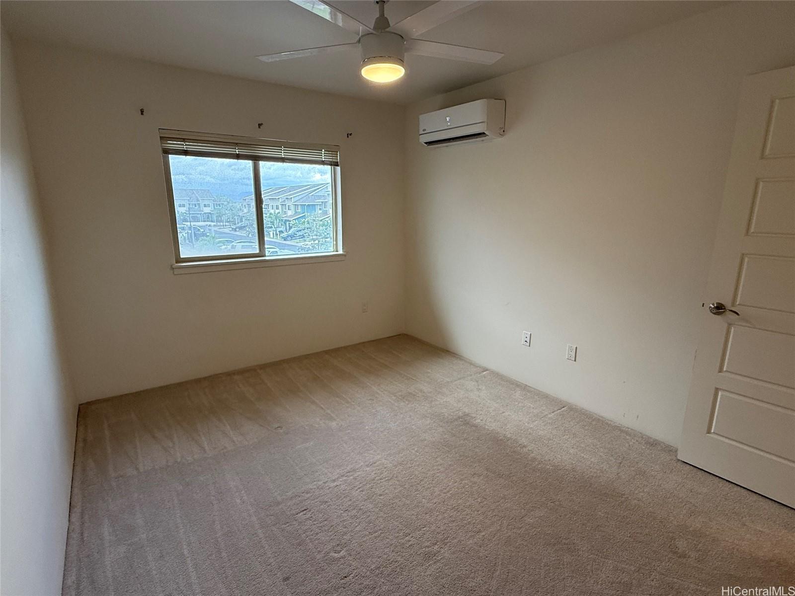 91-3524 Iwikuamo'o Street, Unit 102 Ewa Beach, HI 96706 - Photo 22 of 25 an empty room with a window
