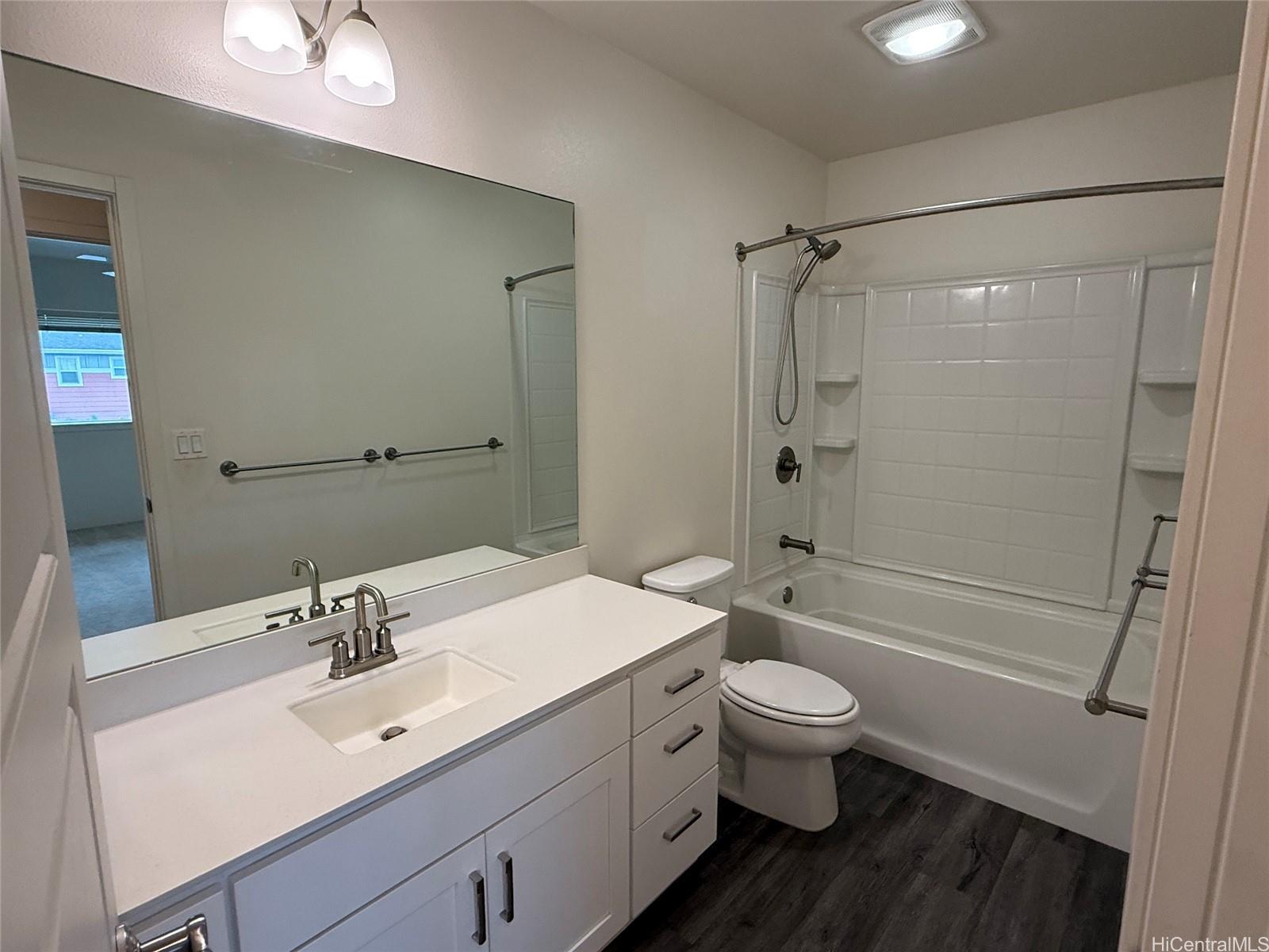 91-3524 Iwikuamo'o Street, Unit 102 Ewa Beach, HI 96706 - Photo 24 of 25 a bathroom with a sink a toilet and shower