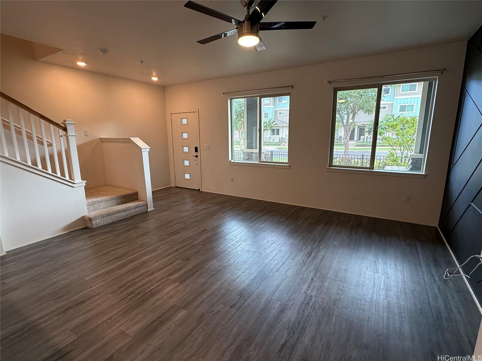 91-3524 Iwikuamo'o Street, Unit 102 Ewa Beach, HI 96706 - Photo 9 of 25 a view of an empty room with wooden floor and a window