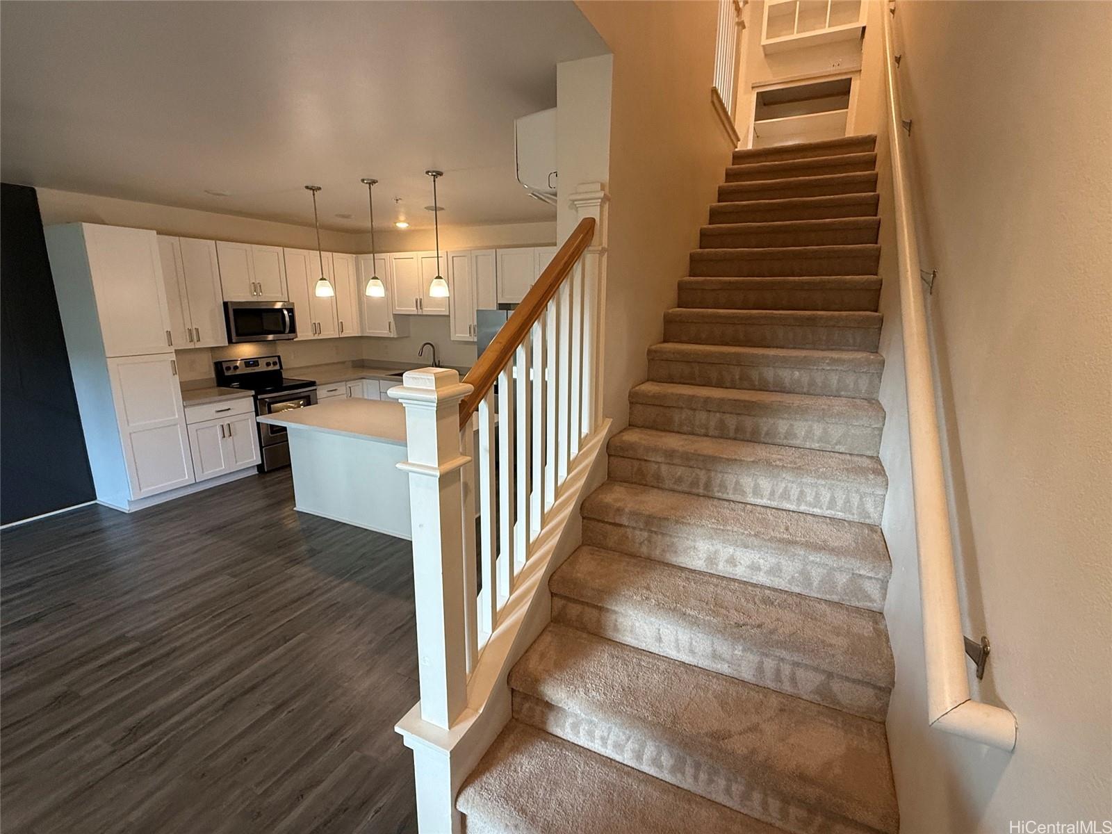 91-3524 Iwikuamo'o Street, Unit 102 Ewa Beach, HI 96706 - Photo 10 of 25 a view of entryway and kitchen with wooden floor