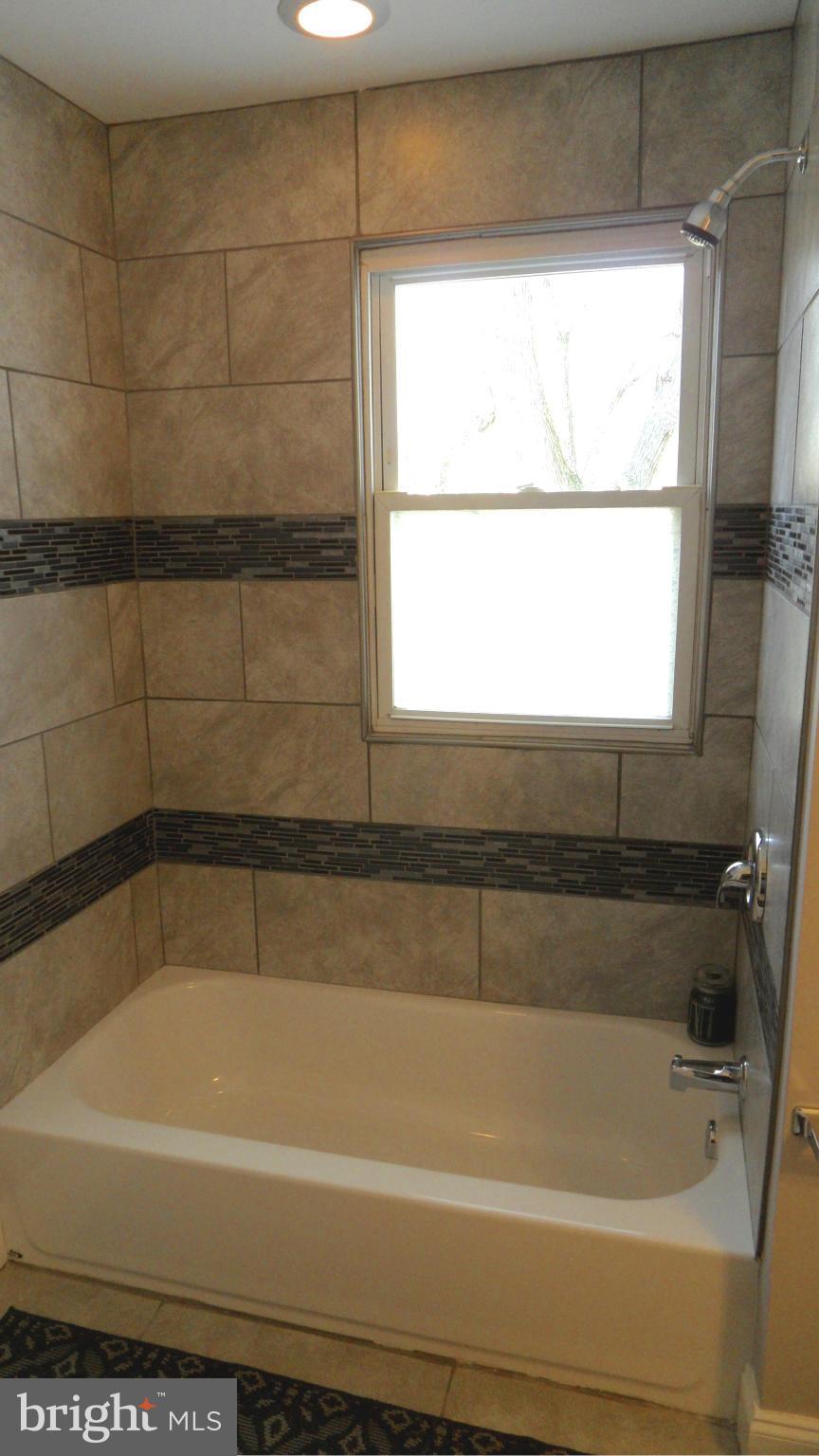 3832 Byfield Road Baltimore, MD 21207 - Photo 13 of 30 a bathroom with a bathtub and window