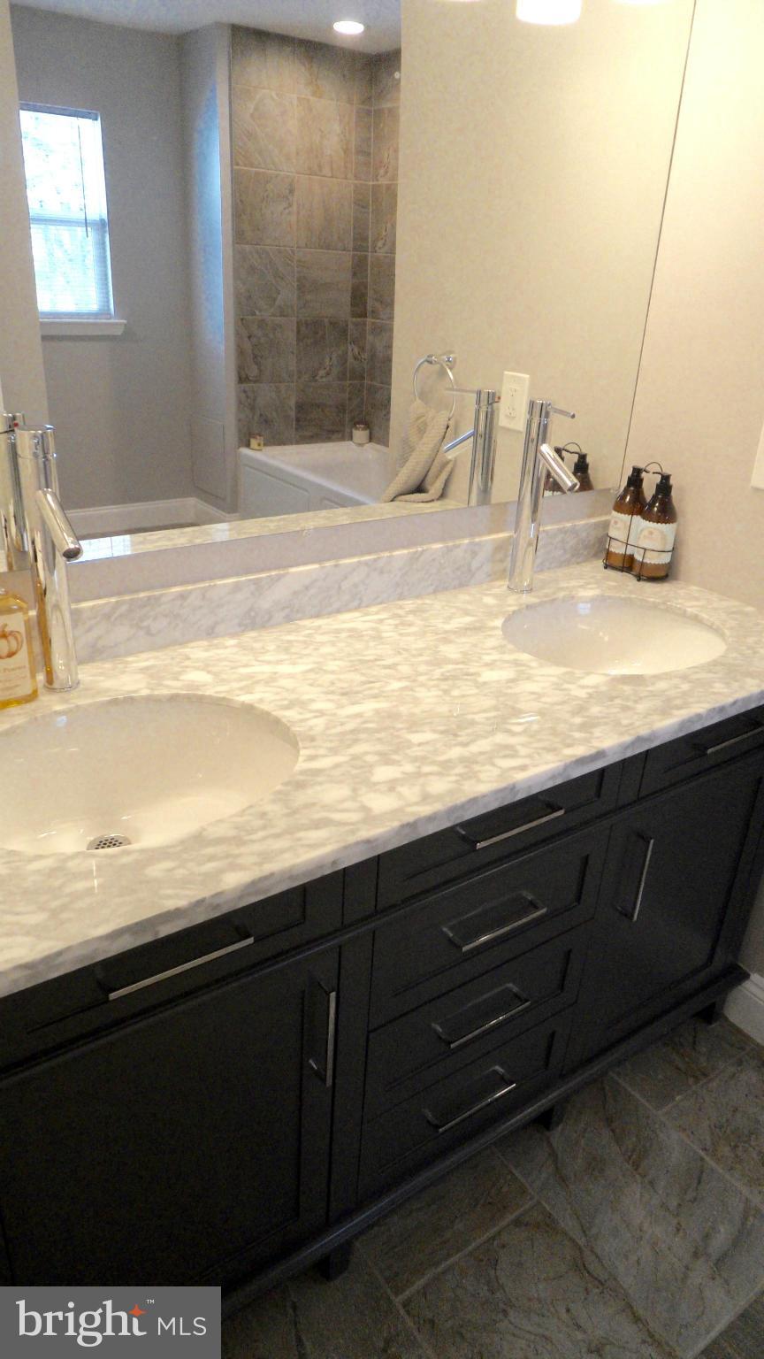 3832 Byfield Road Baltimore, MD 21207 - Photo 18 of 30 a bathroom with a sink and a mirror