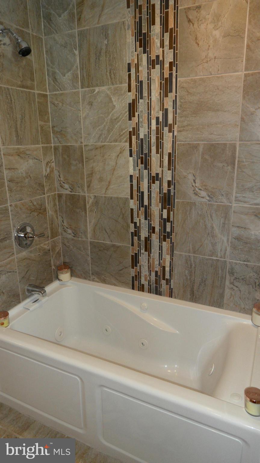 3832 Byfield Road Baltimore, MD 21207 - Photo 19 of 30 a bathroom with a bathtub and shower