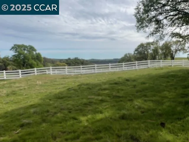 a view of a field with an ocean view