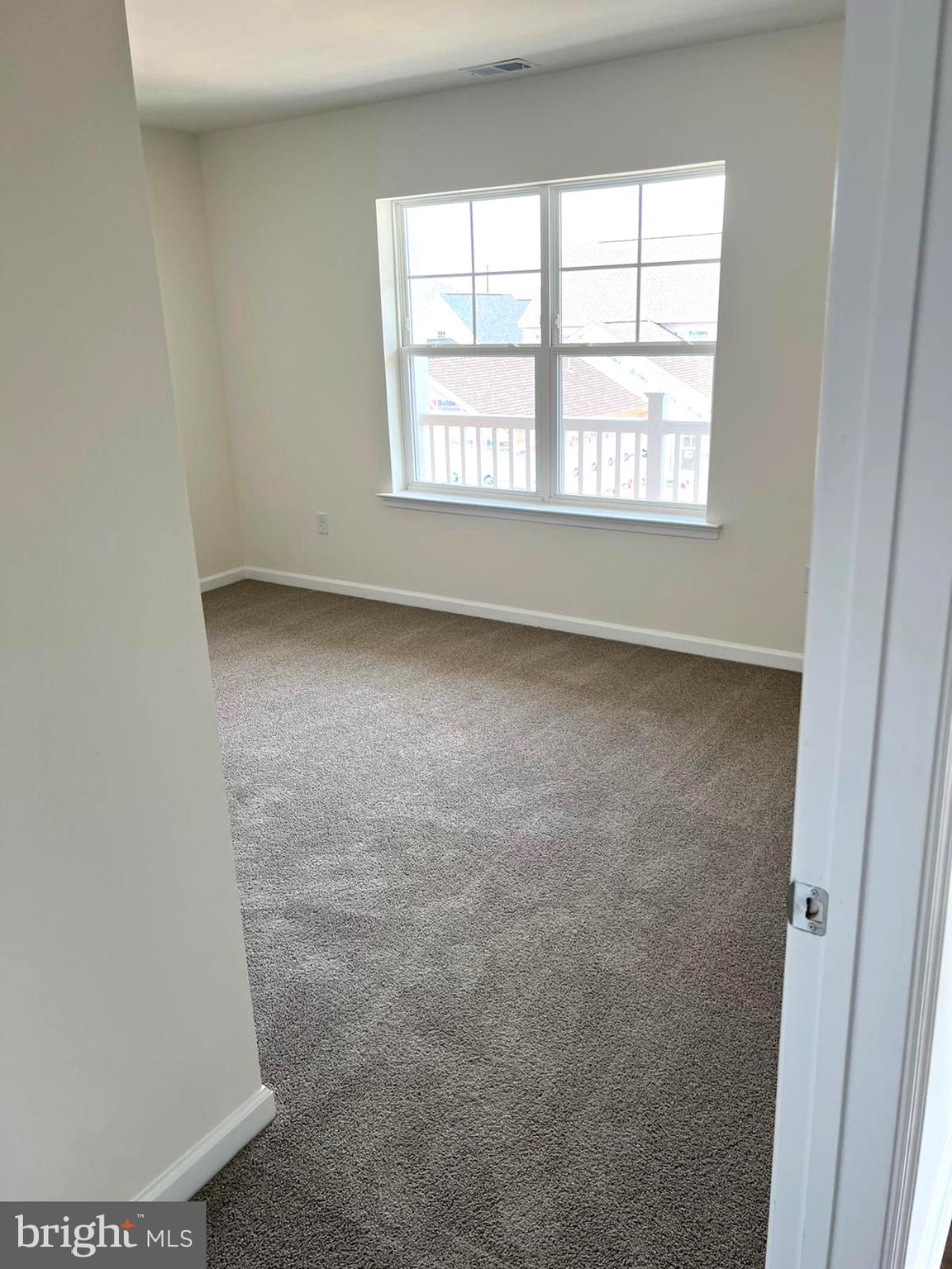 20141 Riesling Lane, Unit 309 Lewes, DE 19958 - Photo 8 of 12 an empty room with a window
