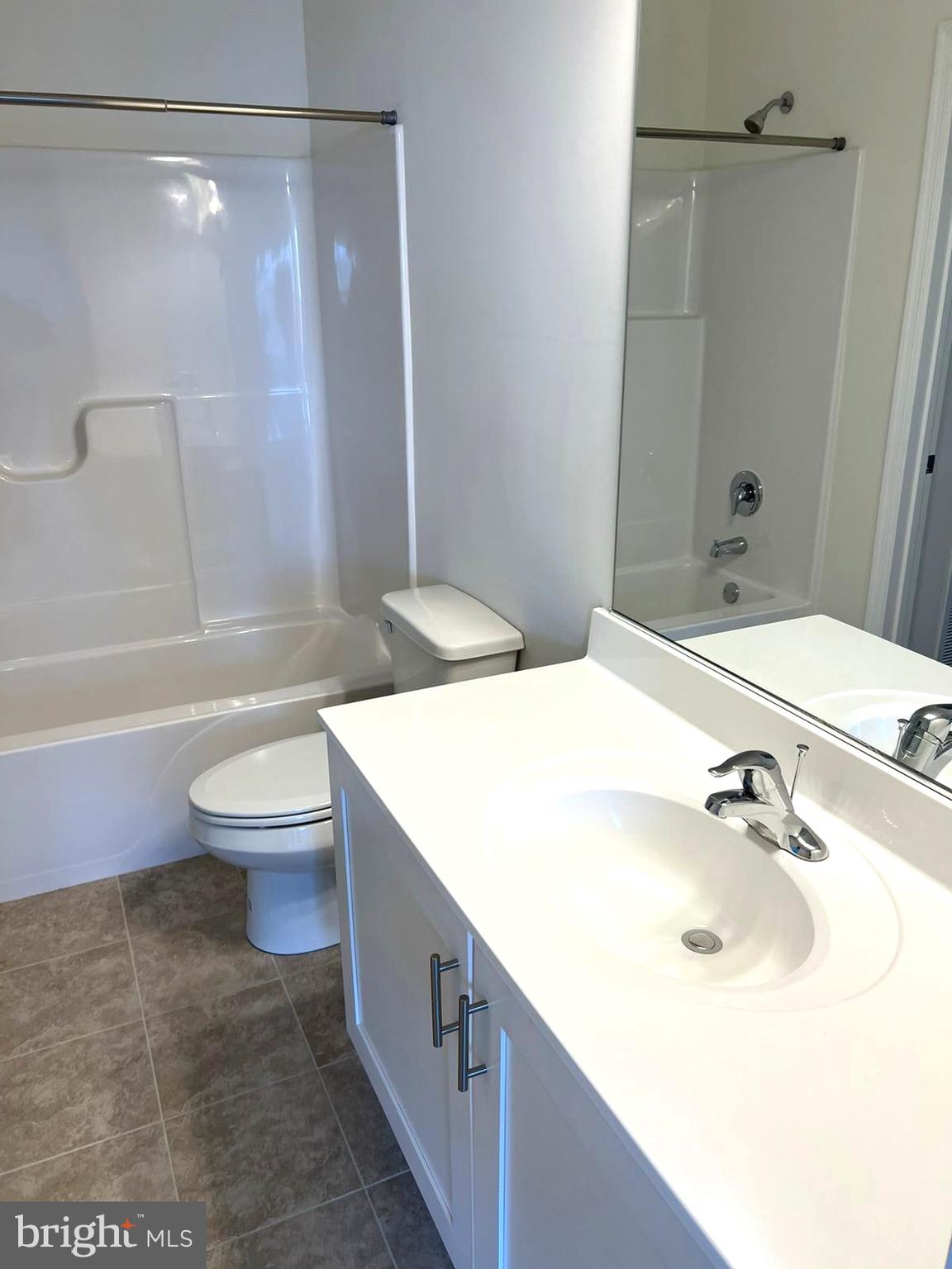 20141 Riesling Lane, Unit 309 Lewes, DE 19958 - Photo 9 of 12 a bathroom with a sink a toilet and shower