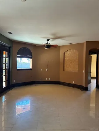 an empty room with furniture and a fireplace