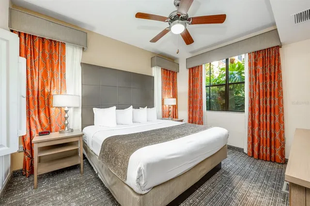 a bedroom with a large bed and a chandelier