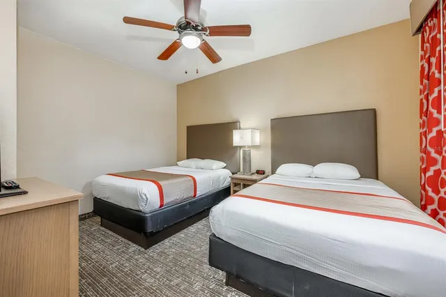 a bedroom with beds and a chandelier